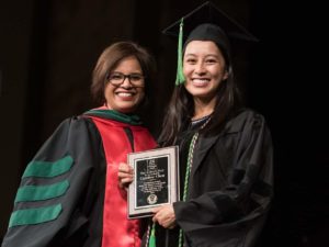 Faculty member presenting award to student