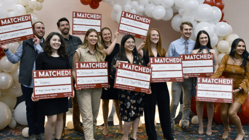 Group of students holding "I matched" signs