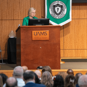 Renee Bornemeier, M.D., emceeing ceremony at podium