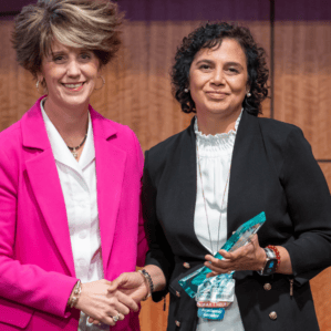 Molly Gathright and Priya Mendiratta with award on stage