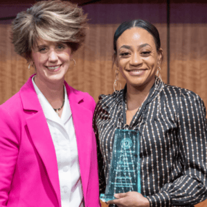 Molly Gathright and Angela Warr holding award on stage