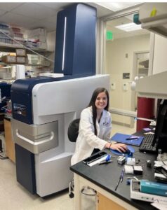 student poses in a scientific lab