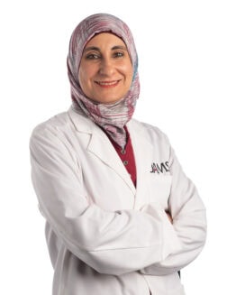 female physician in a white coat and head scarf