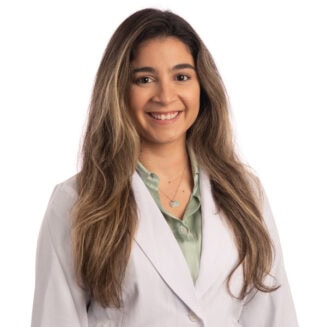 young latina doctor in a white coat