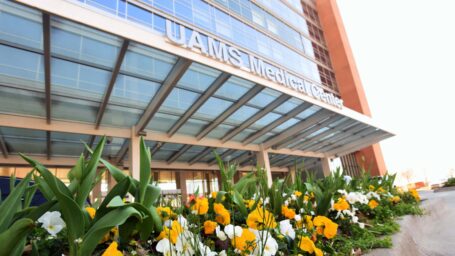 Exterior of the UAMS Medical Center with flowers in the foreground