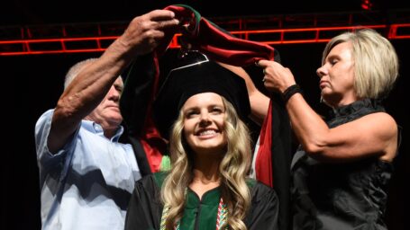 College of Medicine graduate receiving her hood