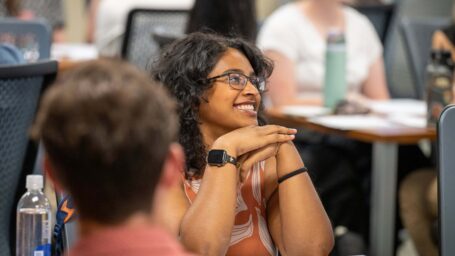 medicalal student smiling at table with other students