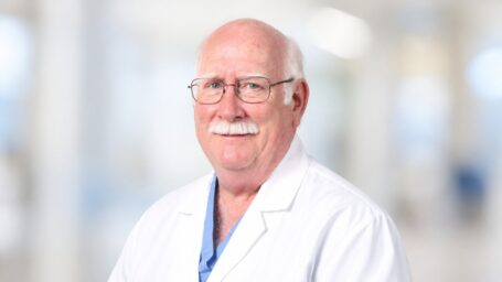 older male physician in a white coat